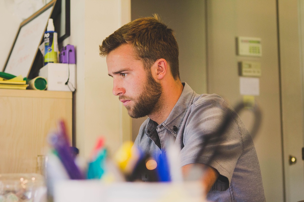 Man, work, desk — How a Hair Salon in Melbourne Can Revitalize Your Look